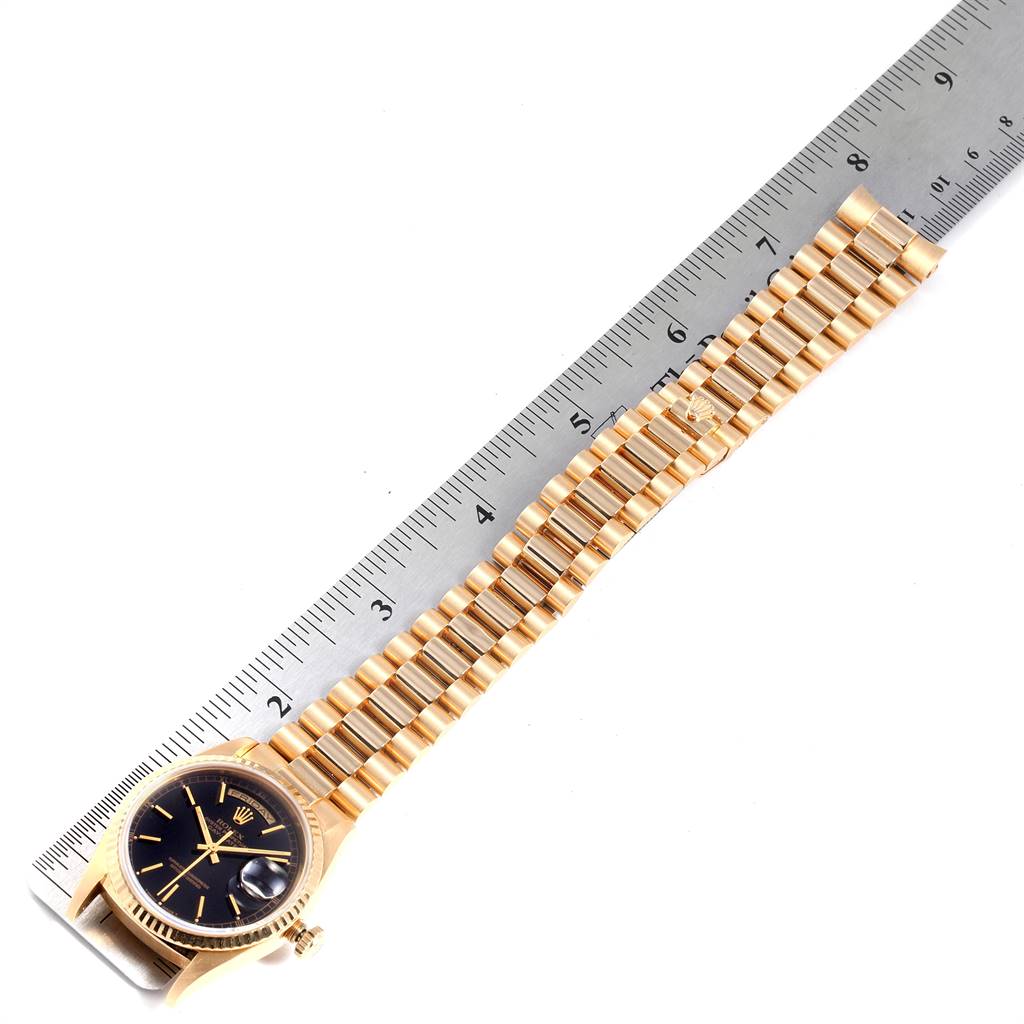 The image shows a Rolex President 18238 Men's Yellow Gold Black Dial 18238 Men's Yellow Gold Black Dial watch, emphasizing the face, band, and a measuring scale.