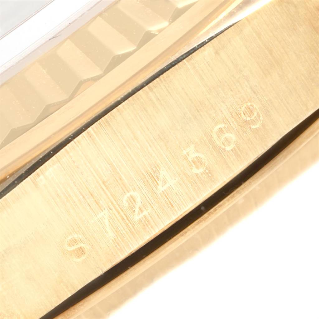 The image shows a close-up of the serial number engraving on the side of the Rolex President 18238 Men's Yellow Gold Black Dial 18238 Men's Yellow Gold Black Dial model watch's gold case bezel.