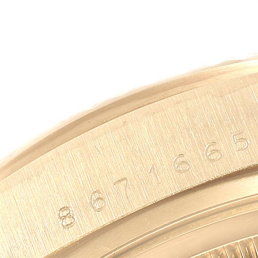 This close-up image shows the engraved serial number on the gold bezel of a Rolex President 18038 Men
s Yellow Gold Champagne Dial 18038 Men
s Yellow Gold Champagne Dial model watch.