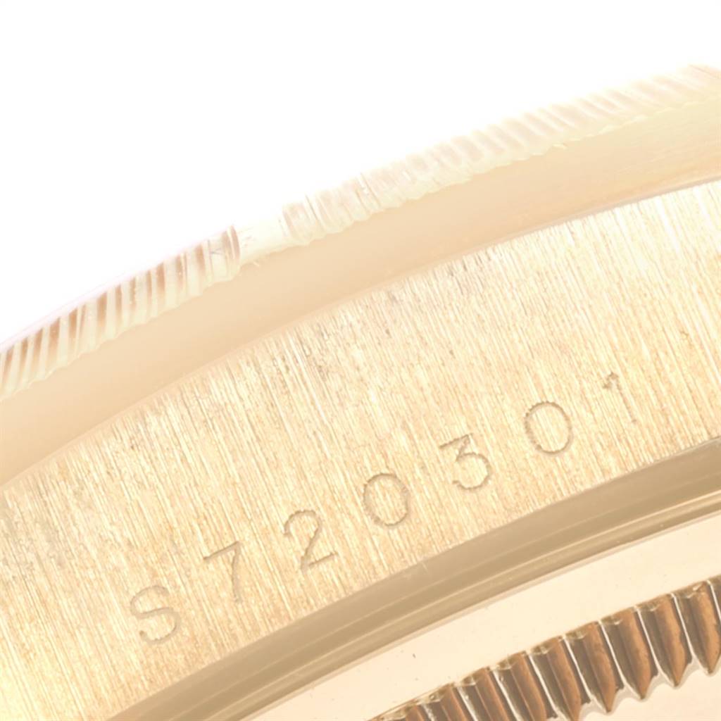 This close-up image of a Rolex President 18248 Men
s Yellow Gold Champagne Dial 18248 Men
s Yellow Gold Champagne Dial model shows the side of the bezel and part of the case with its serial number.