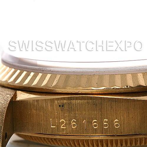 This image shows a close-up of the serial number and fluted bezel on a Rolex President 18238 Men's Yellow Gold White Dial 18238 Men's Yellow Gold White Dial model watch.