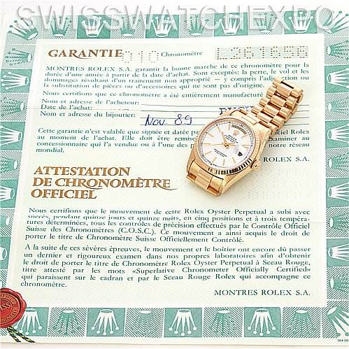 The Rolex President 18238 Men's Yellow Gold White Dial 18238 Men's Yellow Gold White Dial watch is displayed at an angle showing the face and band, placed atop a certificate of authenticity.