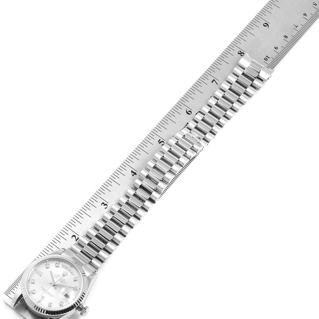 The image shows a Rolex President 118239 Men's White Gold Silver Dial 118239 Men's White Gold Silver Dial model watch laid flat with a ruler beside it, highlighting the bracelet and face.