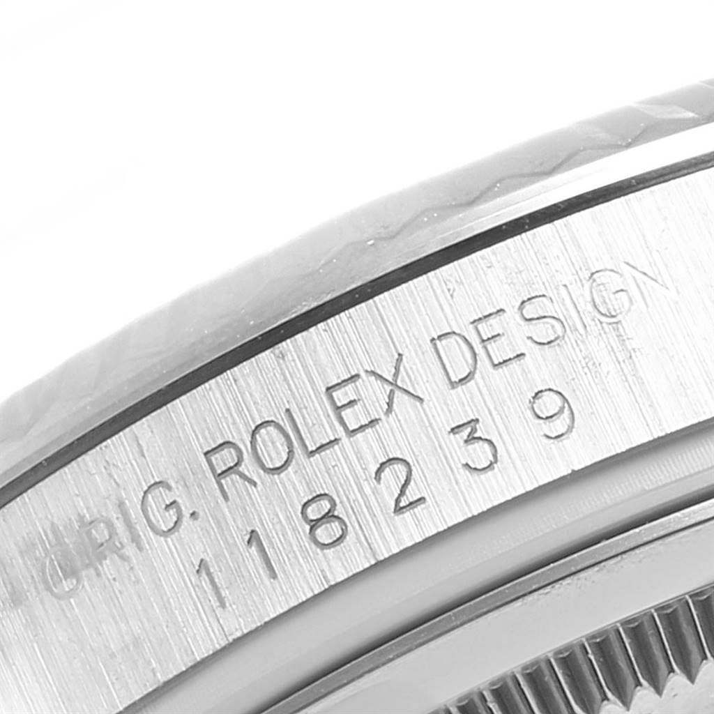 This close-up image shows the engraved case edge of the Rolex President 118239 Men's White Gold Silver Dial 118239 Men's White Gold Silver Dial model watch.