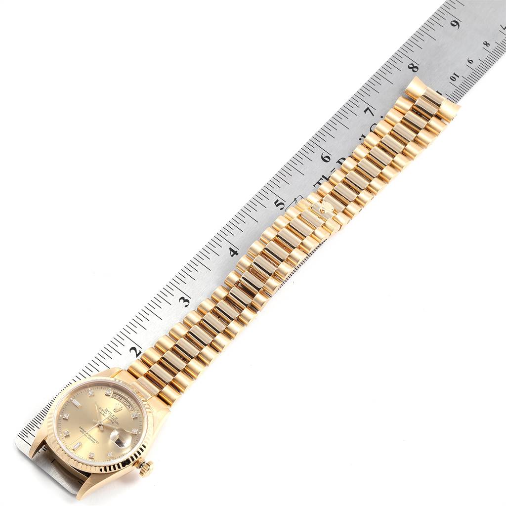 The image shows a Rolex President 18238 Men
s Yellow Gold Champagne Dial 18238 Men
s Yellow Gold Champagne Dial model watch laid flat, with the dial and bracelet clearly visible, alongside a ruler for scale.