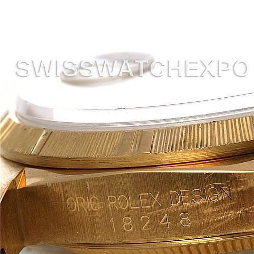 This close-up image shows the side of a Rolex President 18248 Men's Yellow Gold White Dial 18248 Men's Yellow Gold White Dial model watch, highlighting the serial number and the fluted bezel design.