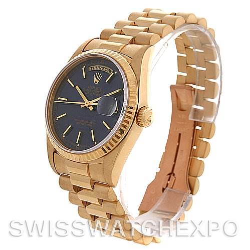 The image shows a Rolex President 18238 Men's Yellow Gold Blue Dial 18238 Men's Yellow Gold Blue Dial model watch from a three-quarter angle, highlighting its gold case and bracelet, black dial, and fluted bezel.