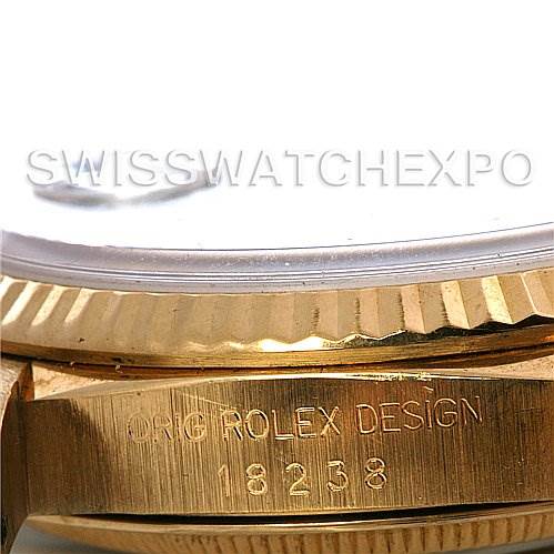 This close-up shows the side engraving and part of the bezel of a Rolex President 18238 Men's Yellow Gold Blue Dial 18238 Men's Yellow Gold Blue Dial model.