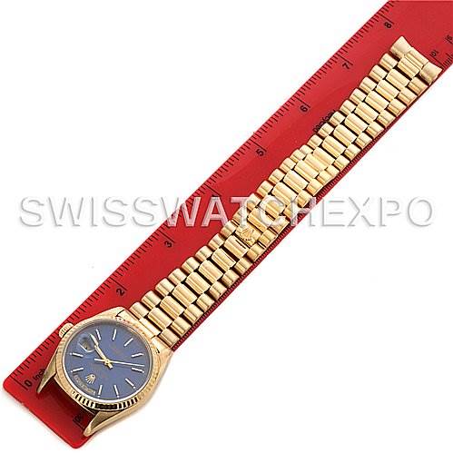 The image shows the front view of a Rolex President 18238 Men's Yellow Gold Blue Dial 18238 Men's Yellow Gold Blue Dial model watch, including the face, bezel, and full bracelet, laid against a ruler.