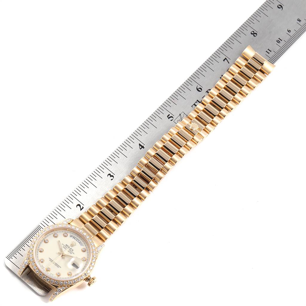The image shows a top-down view of a Rolex President 18388 Men's Yellow Gold White Dial 18388 Men's Yellow Gold White Dial model watch, displaying the face, bezel, and full bracelet next to a ruler.