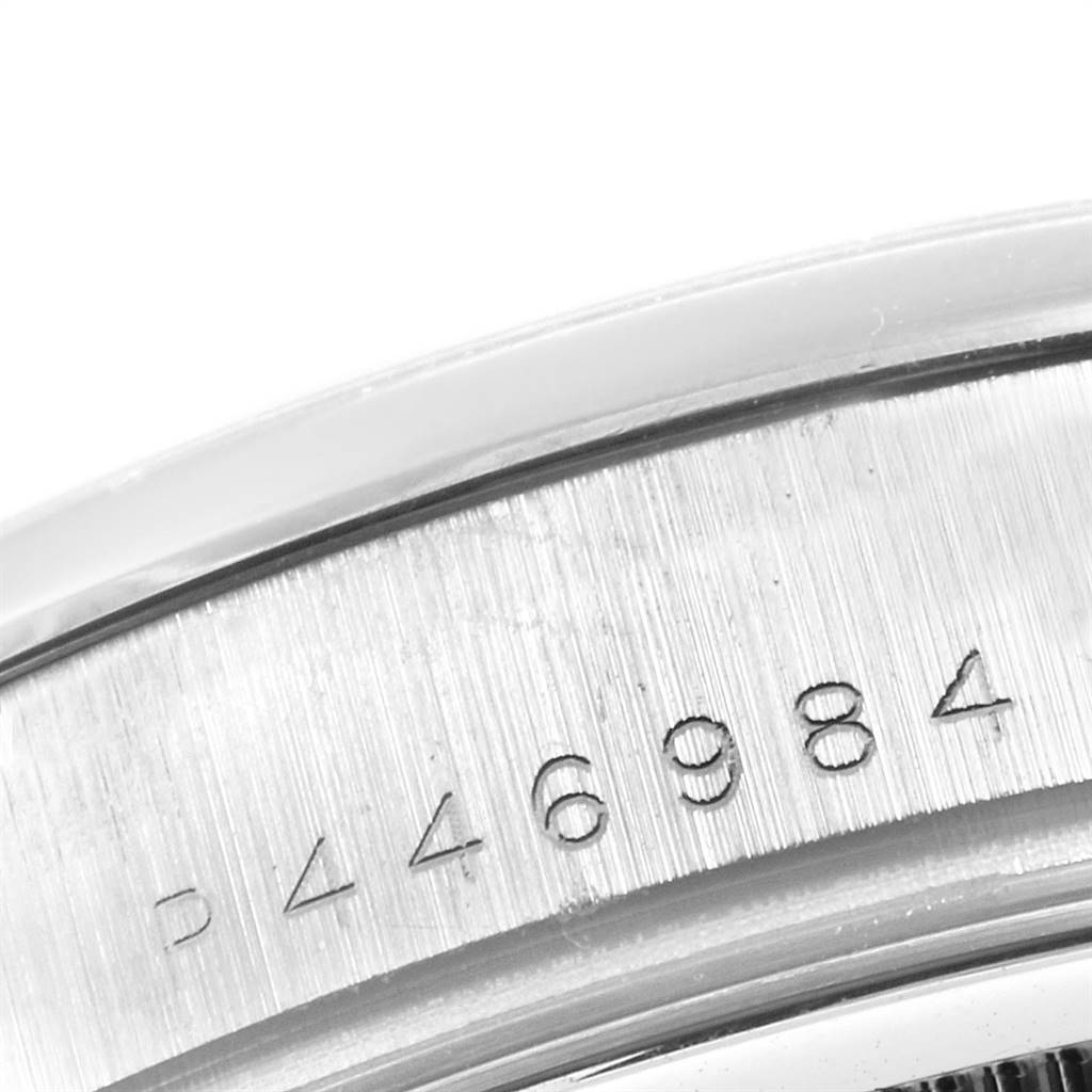 This image shows a close-up of the serial number engraved on the case of the Rolex President 118209 Men's White Gold Silver Dial 118209 Men's White Gold Silver Dial model watch.