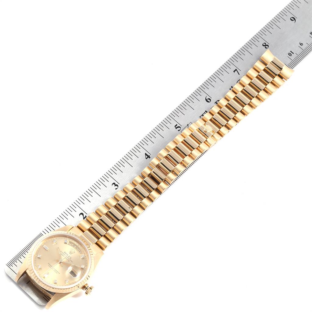 The image shows a Rolex President 18238 Men
s Yellow Gold Champagne Dial 18238 Men
s Yellow Gold Champagne Dial watch laid out flat next to a ruler, displaying the dial and bracelet.