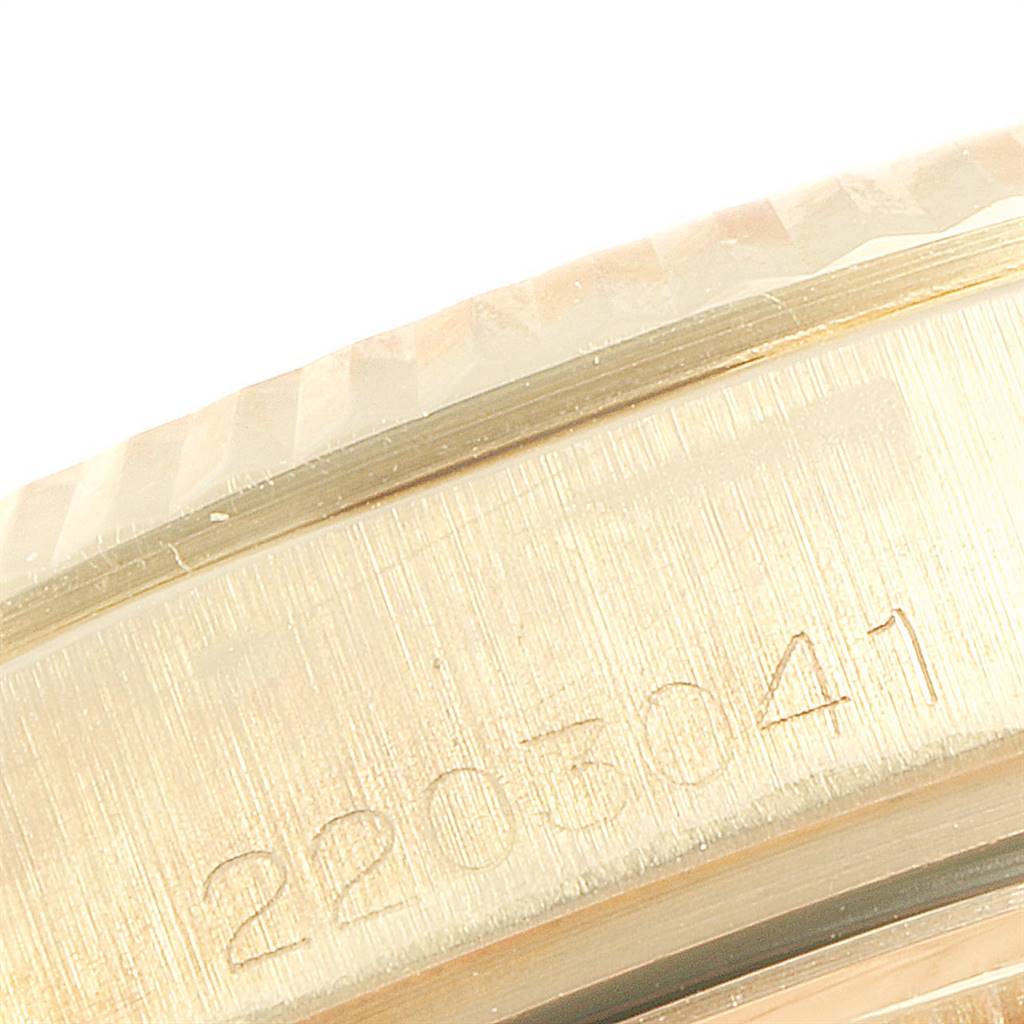This image shows a close-up of the serial number and fluted bezel of a President model Rolex watch.