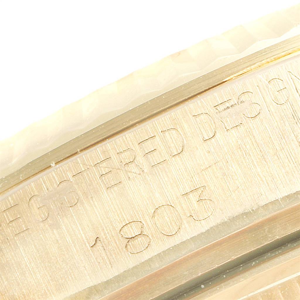This close-up image shows the engraved side of a Rolex President 1803 Men's Yellow Gold Champagne Dial 1803 Men's Yellow Gold Champagne Dial model watch case with the serial number partially visible.