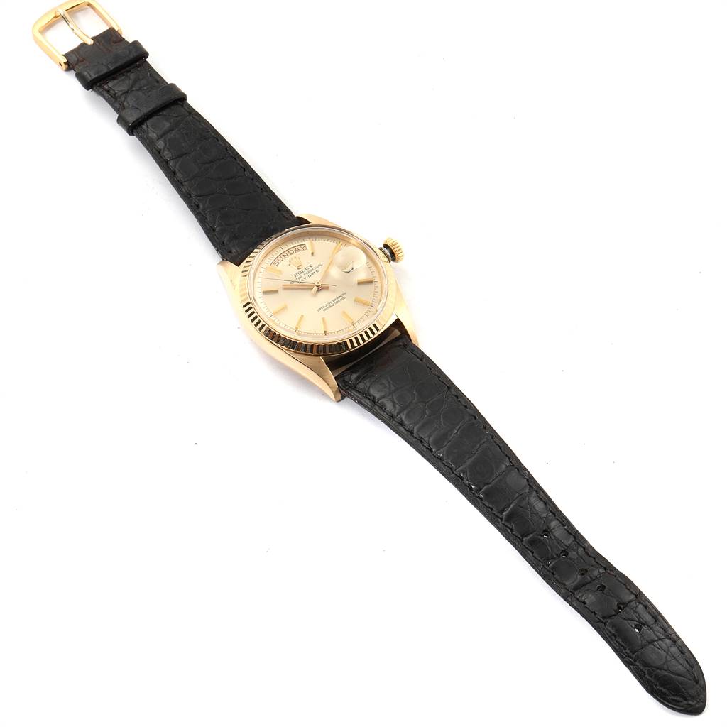 The Rolex President 1803 Men's Yellow Gold Champagne Dial 1803 Men's Yellow Gold Champagne Dial model watch is shown from a top-angle view, displaying the dial, bezel, crown, and black leather strap.