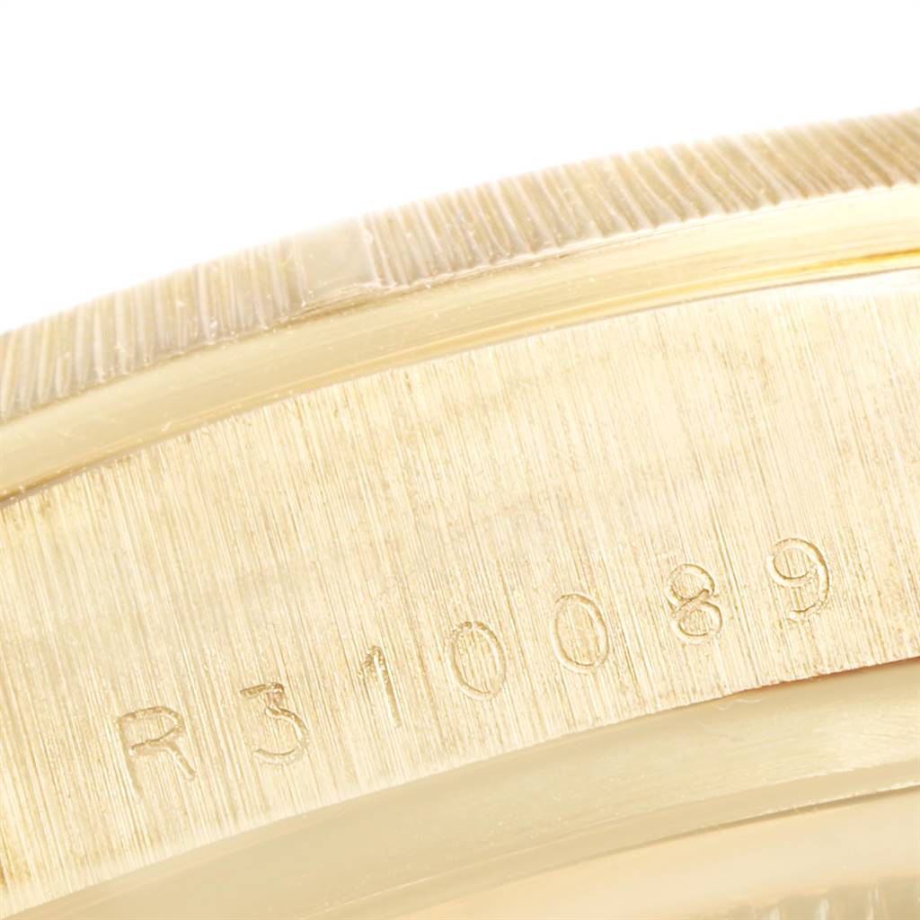 This image shows a close-up of the case and the engraved serial number of a Rolex President 18078 Men's Yellow Gold Black Dial 18078 Men's Yellow Gold Black Dial model watch.