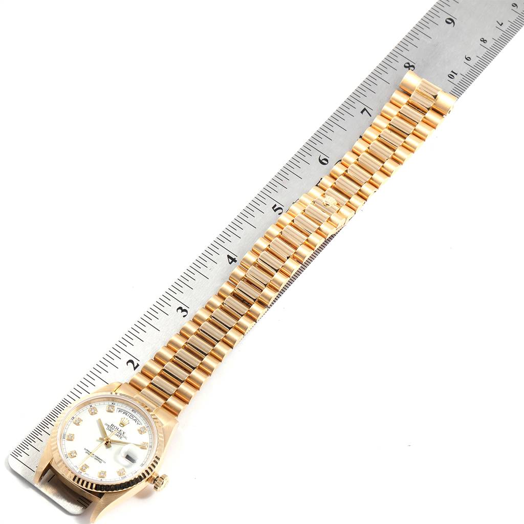 The image showcases a Rolex President 18238 Men's Yellow Gold White Dial 18238 Men's Yellow Gold White Dial model watch, viewed from a top-down angle, with a ruler for scale.