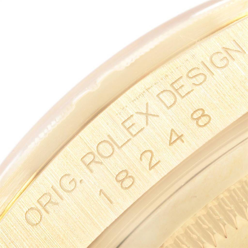 The image shows a close-up view of the side casing of the Rolex President 18248 Men's Yellow Gold Black Dial 18248 Men's Yellow Gold Black Dial model, highlighting its engraved details.