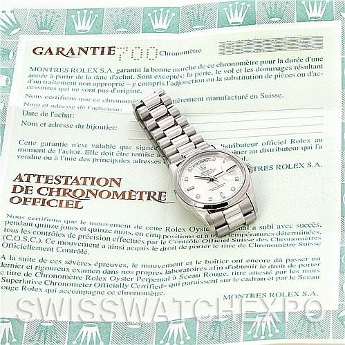 The image shows a Rolex President 18206 Men's Platinum Silver Dial 18206 Men's Platinum Silver Dial model watch laid flat on top of its guarantee and chronometer certification documents.