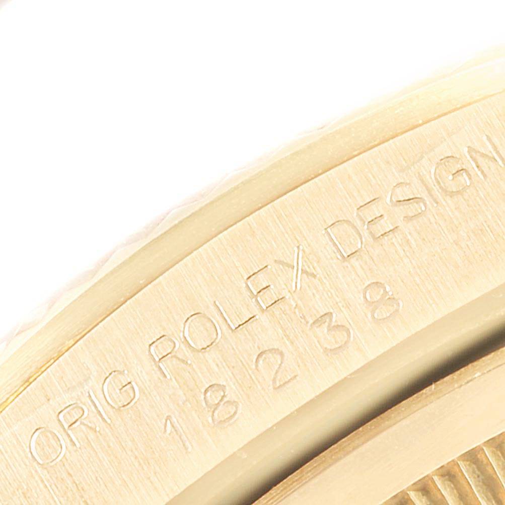 This image shows a close-up of the engraved bezel of the Rolex President 18238 Men
s Yellow Gold Champagne Dial 18238 Men
s Yellow Gold Champagne Dial model with partial model numbers visible.
