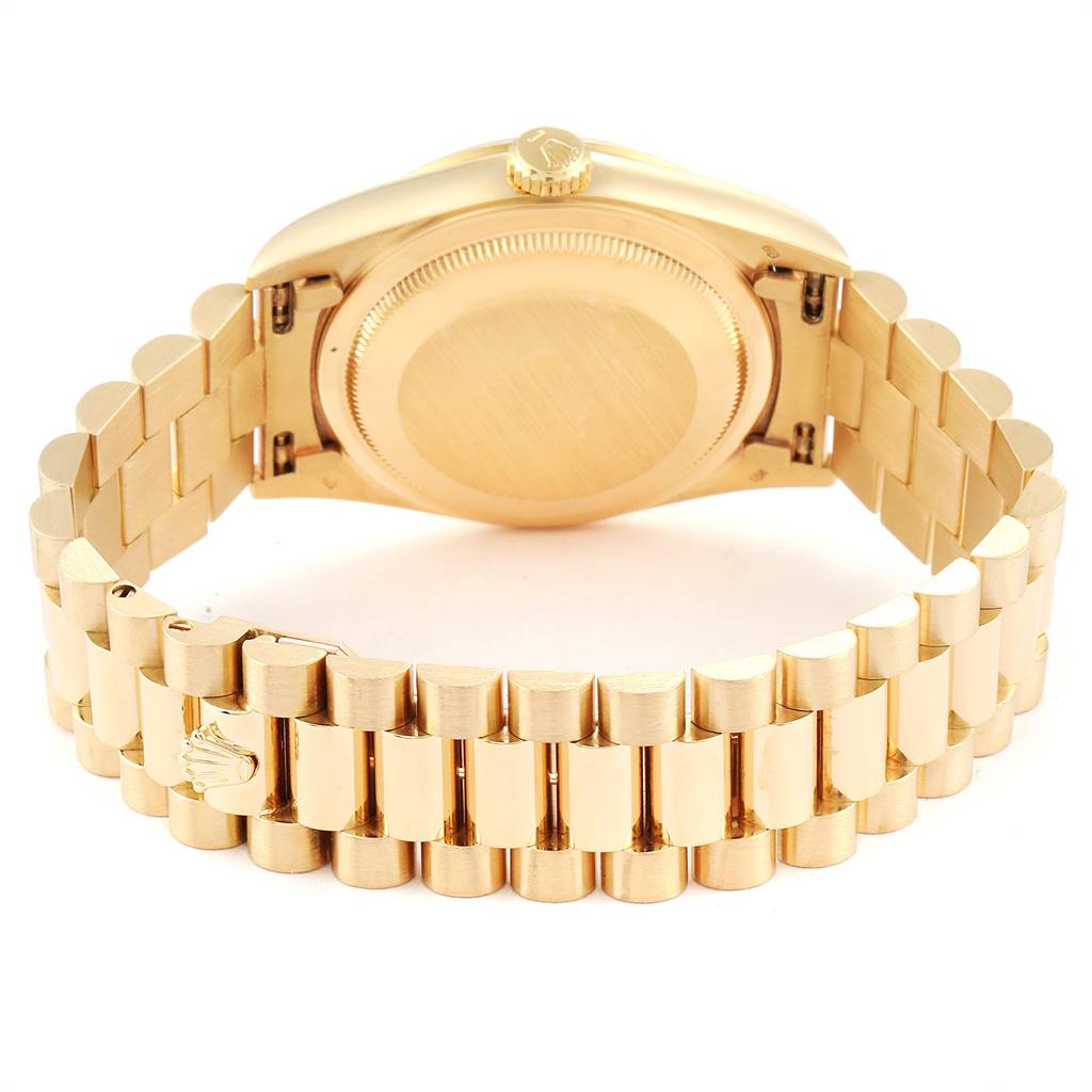 The image shows the back view of a Rolex President 18238 Men
s Yellow Gold Champagne Dial 18238 Men
s Yellow Gold Champagne Dial model watch, featuring its gold case and bracelet.