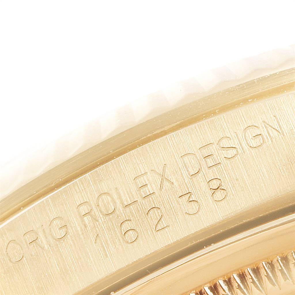The image shows a close-up of the bezel and part of the case side of a Rolex President 16238 Men
s Yellow Gold Champagne Dial 16238 Men
s Yellow Gold Champagne Dial model watch, including the engraved serial and model numbers.
