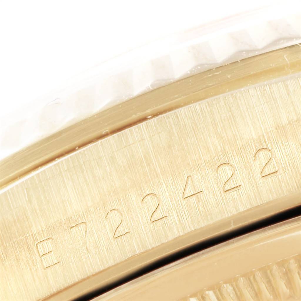 This image shows an extreme close-up of the side of the Rolex President 16238 Men
s Yellow Gold Champagne Dial 16238 Men
s Yellow Gold Champagne Dial model watch, highlighting its serial number engraving.