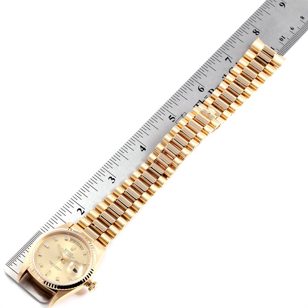 The image shows a Rolex President 18238 Men's Yellow Gold Champagne Dial 18238 Men's Yellow Gold Champagne Dial model watch placed next to a ruler, displaying the full bracelet and watch face at an overhead angle.