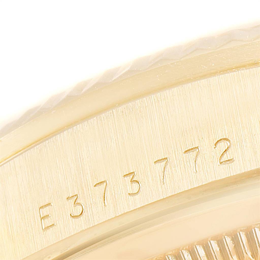 The image shows a close-up of the serial number engraved on the side of a Rolex President 18238 Men
s Yellow Gold Mother of Pearl Dial 18238 Men
s Yellow Gold Mother of Pearl Dial watch case.