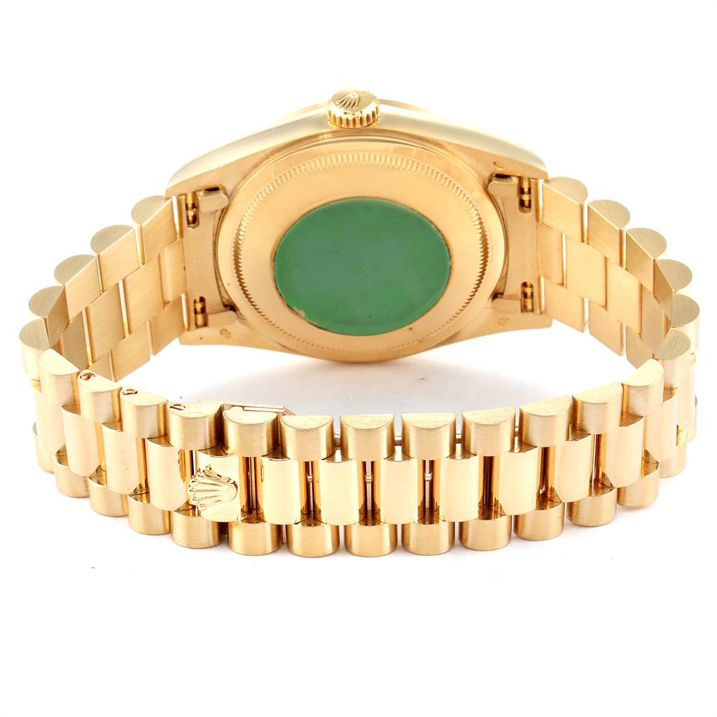 The Rolex President 18238 Men
s Yellow Gold Mother of Pearl Dial 18238 Men
s Yellow Gold Mother of Pearl Dial model watch is shown from the back, displaying its case back and gold bracelet.