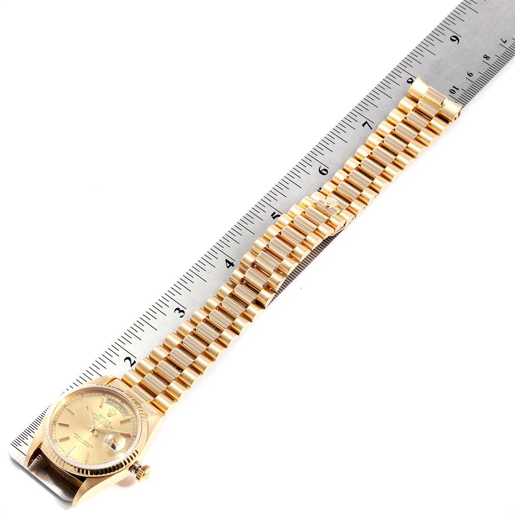 The image shows a Rolex President 18038 Men
s Yellow Gold Champagne Dial 18038 Men
s Yellow Gold Champagne Dial model watch with a gold bracelet, positioned next to a ruler for measurement.