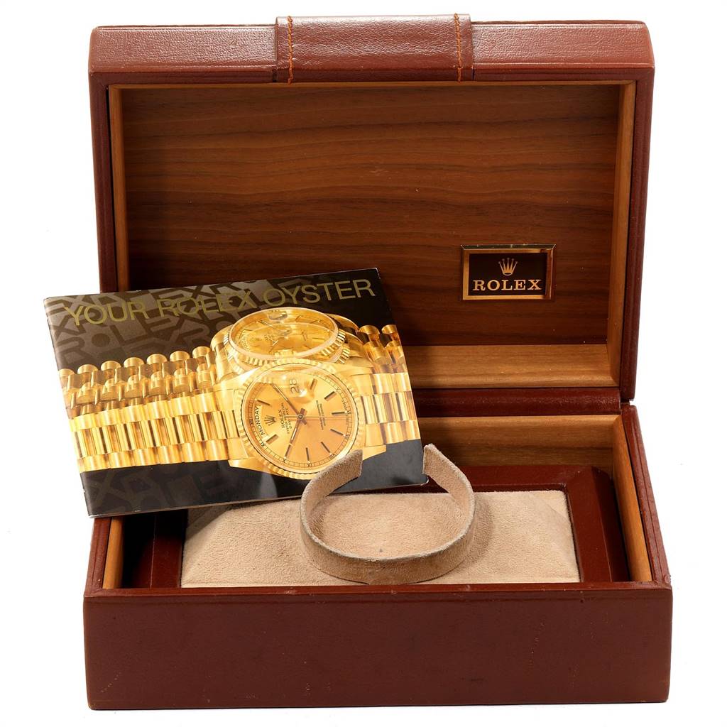 The image shows an open box for the Rolex President 18038 Men
s Yellow Gold Champagne Dial 18038 Men
s Yellow Gold Champagne Dial model watch, including a brochure and a cushion inside.
