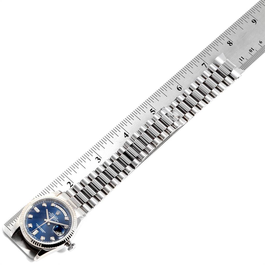 The image shows a Rolex President 118239 Men's White Gold Blue Dial 118239 Men's White Gold Blue Dial model watch placed alongside a ruler, focusing on the bracelet and watch face.
