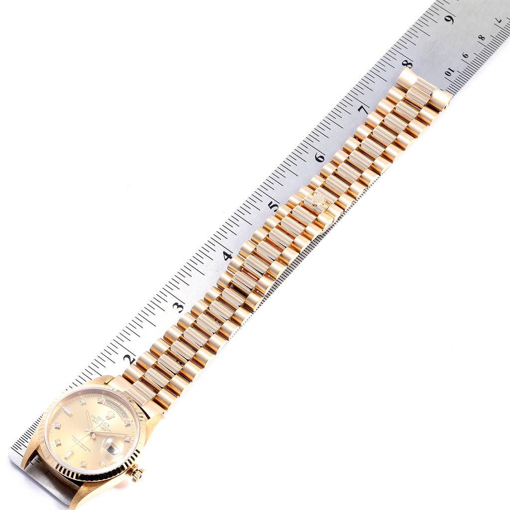 The image shows a side view of a gold Rolex President 18238 Men
s Yellow Gold Champagne Dial 18238 Men
s Yellow Gold Champagne Dial model watch with its strap measured against a ruler.