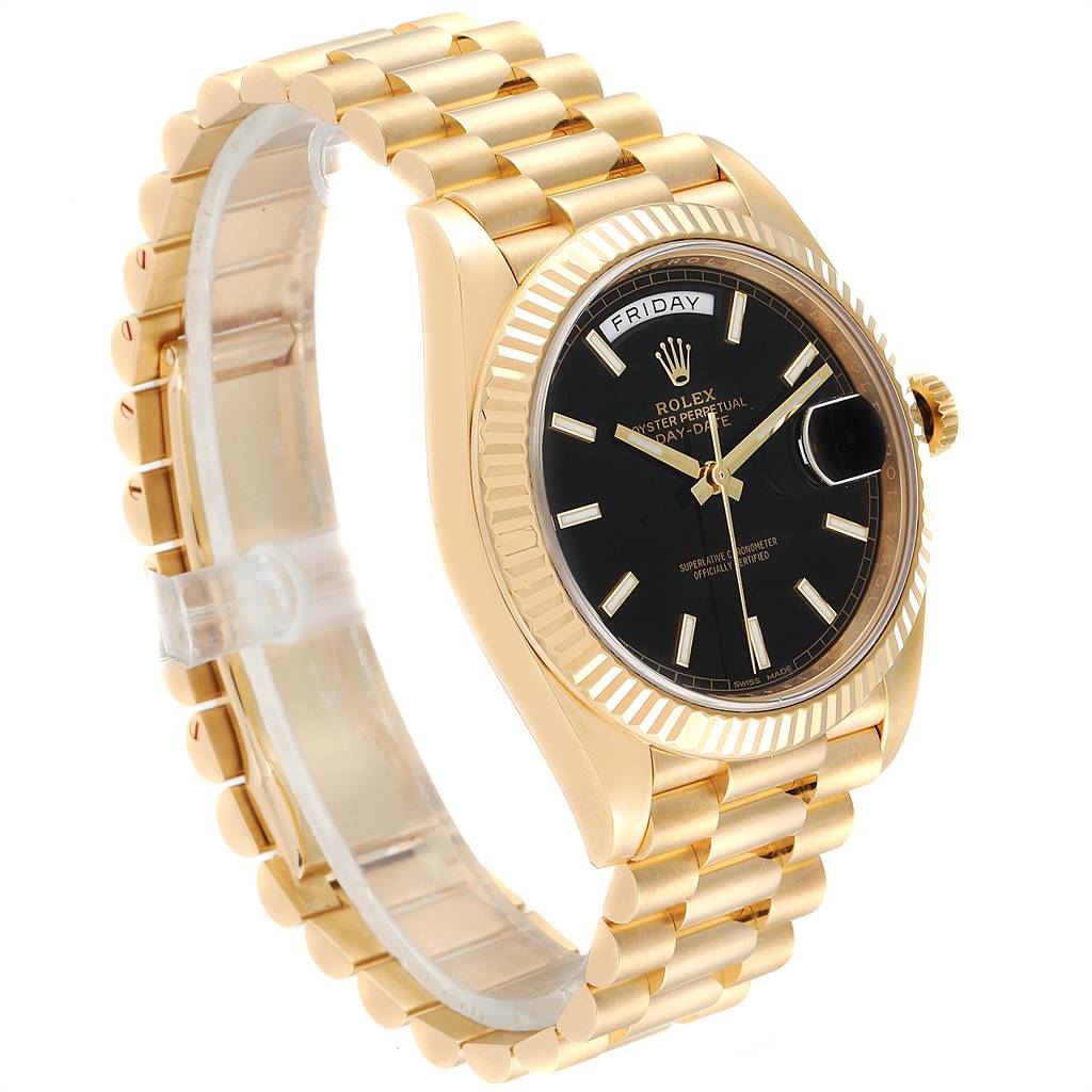 The Rolex President 228238 Men
s Yellow Gold Black Dial 228238 Men
s Yellow Gold Black Dial model watch is shown at a side angle, displaying its gold bracelet, black dial, and fluted bezel.