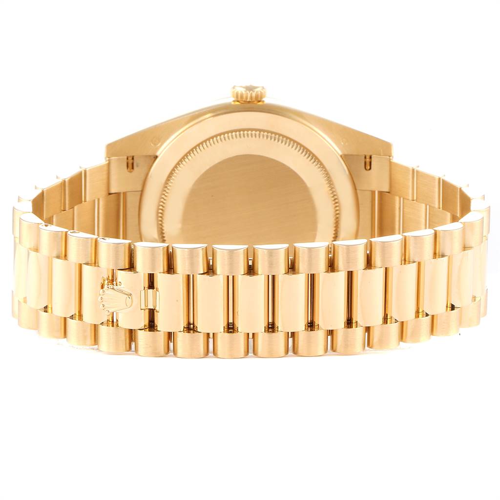 The image shows the rear view of a Rolex President 228238 Men
s Yellow Gold Black Dial 228238 Men
s Yellow Gold Black Dial watch, highlighting its case back and gold bracelet.