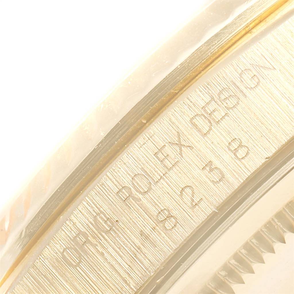 This close-up image shows the engraved wording and part of the bezel on a Rolex President 18238 Men
s Yellow Gold Champagne Dial 18238 Men
s Yellow Gold Champagne Dial model watch.
