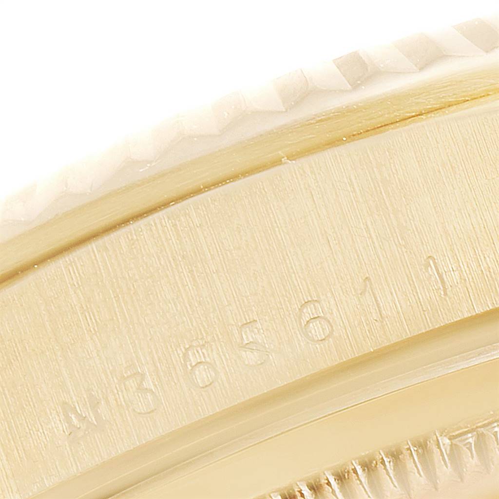 This close-up image shows the side of the bezel and part of the casing of a Rolex President 18238 Men
s Yellow Gold Champagne Dial 18238 Men
s Yellow Gold Champagne Dial model watch with visible serial numbers.