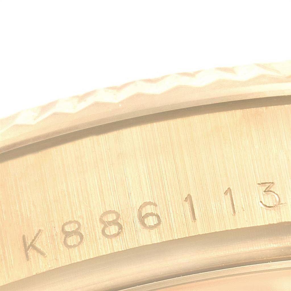 This close-up image of a Rolex President 118238 Men
s Yellow Gold Champagne Dial 118238 Men
s Yellow Gold Champagne Dial model shows part of the band with engraved serial numbers.