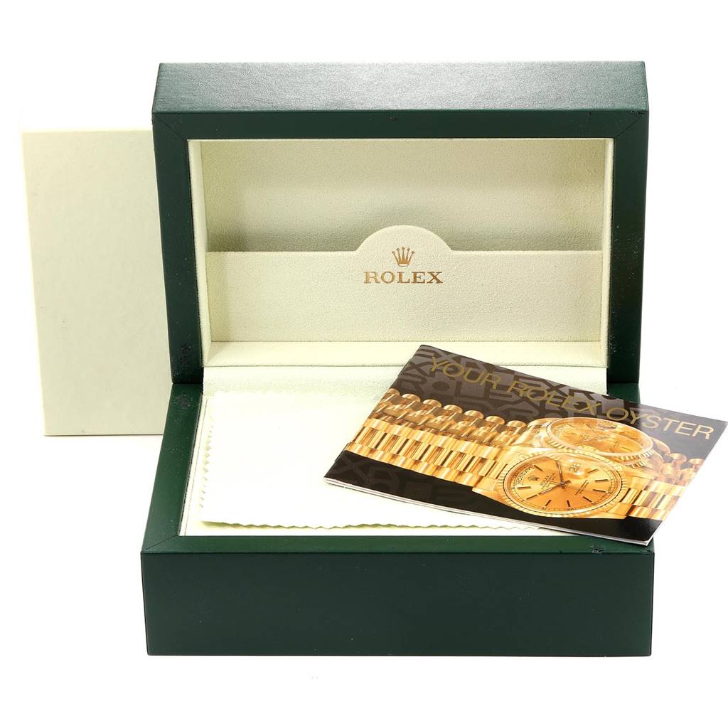 The image shows an empty Rolex President 118238 Men
s Yellow Gold Champagne Dial 118238 Men
s Yellow Gold Champagne Dial watch box with its lid open and a booklet inside.