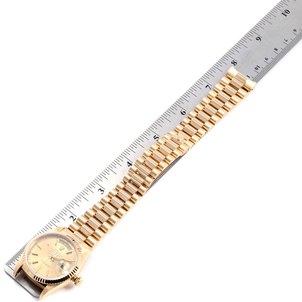 The image shows a side view of a Rolex President 18238 Men
s Yellow Gold Champagne Dial 18238 Men
s Yellow Gold Champagne Dial model watch, including the face, bezel, and bracelet, measured against a ruler.