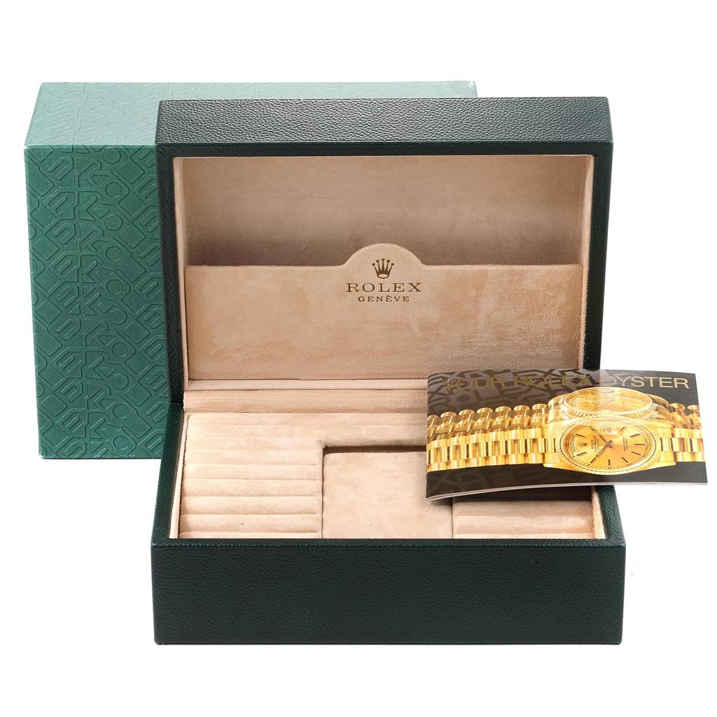 The image shows an open Rolex box for the President model, revealing beige interior compartments and an informational booklet.