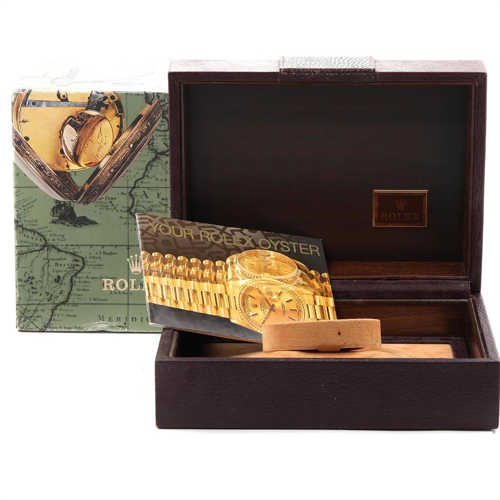 The image shows a Rolex President 18238 Men
s Yellow Gold Champagne Dial 18238 Men
s Yellow Gold Champagne Dial model watch box and manual, with the box open, revealing an empty cushioned interior.