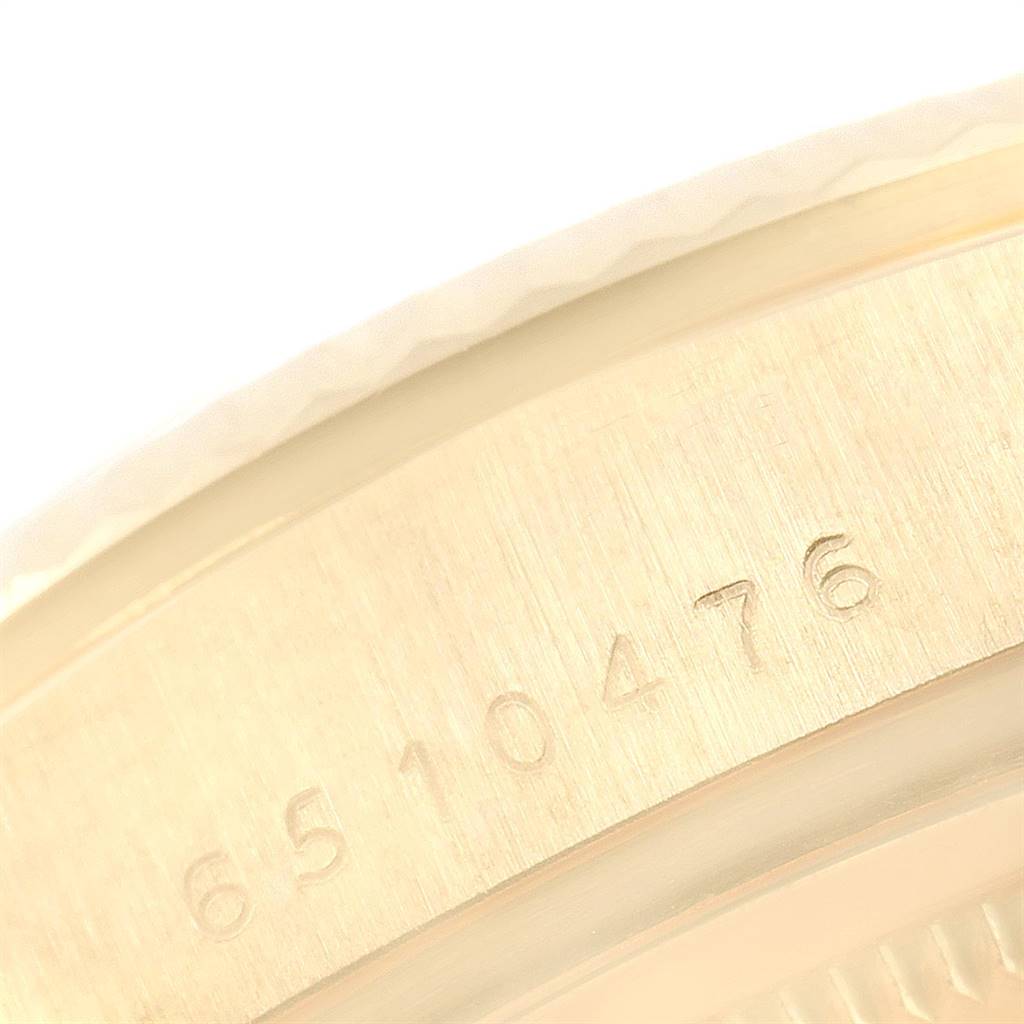 This close-up image shows the engraved serial number on the case of a Rolex President 18038 Men's Yellow Gold Champagne Dial 18038 Men's Yellow Gold Champagne Dial model watch.