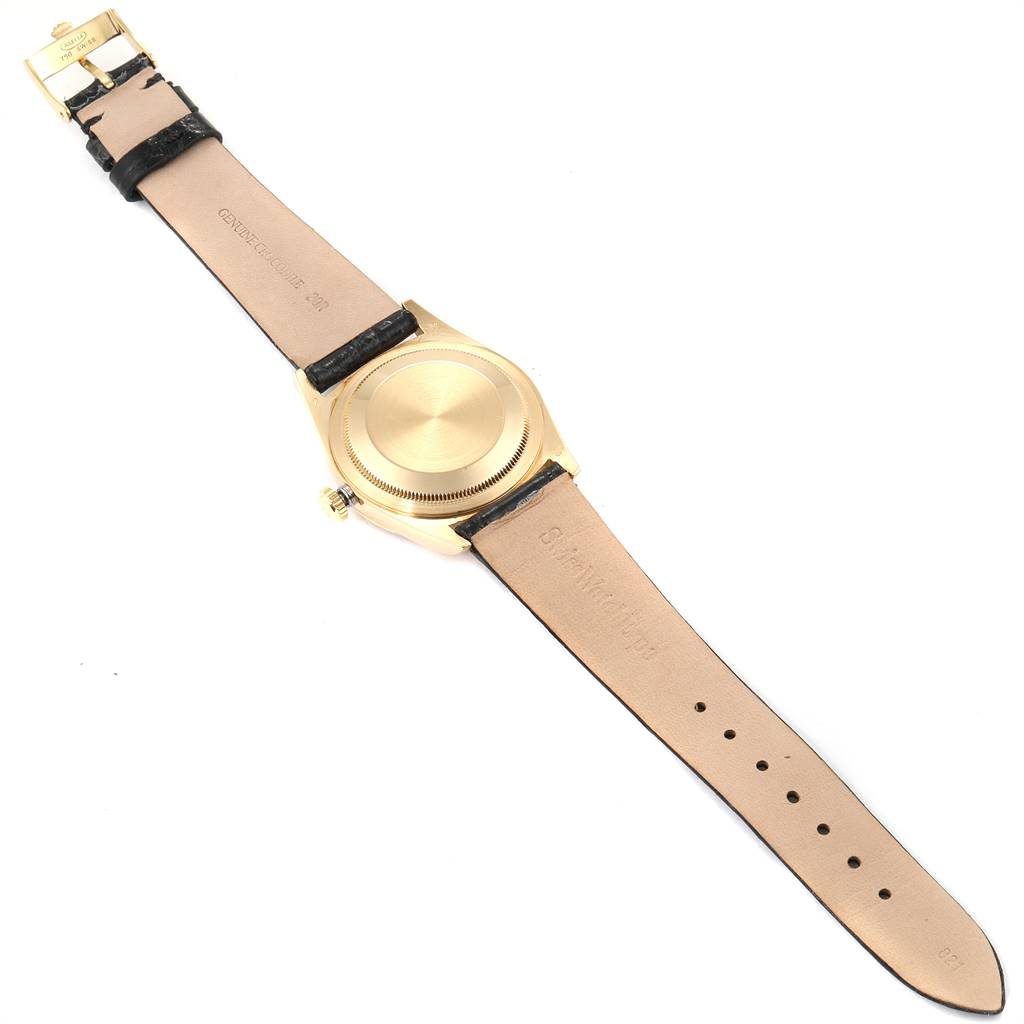 The image shows the back view of a Rolex President 16238 Men
s Yellow Gold Champagne Dial 16238 Men
s Yellow Gold Champagne Dial model watch, focusing on its rear case, crown, and leather straps.