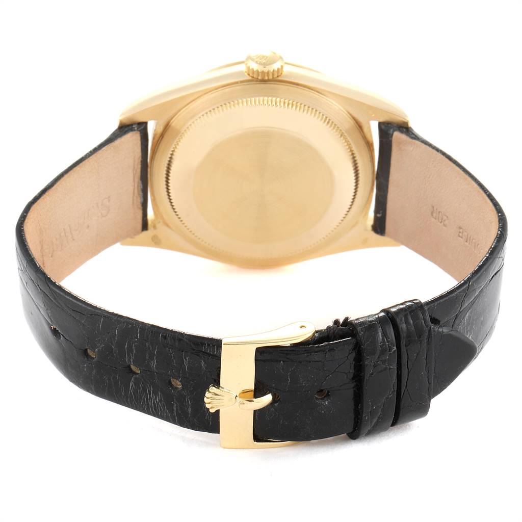 The image shows the back view of a Rolex President 16238 Men
s Yellow Gold Champagne Dial 16238 Men
s Yellow Gold Champagne Dial model watch with a black leather strap and gold buckle.