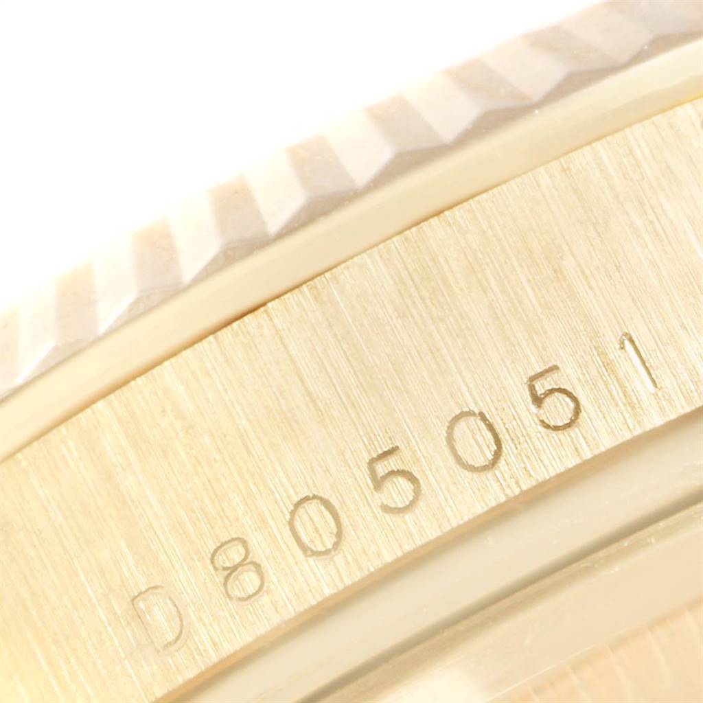 This close-up angle shows the fluted bezel and serial number engraving on the case of a Rolex President 118338 Men's Yellow Gold Champagne Dial 118338 Men's Yellow Gold Champagne Dial model watch.