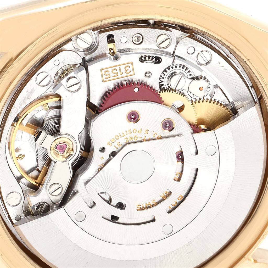 The image shows a close-up of the movement mechanism of a Rolex President 118338 Men's Yellow Gold Champagne Dial 118338 Men's Yellow Gold Champagne Dial model watch, highlighting its intricate gears and components.
