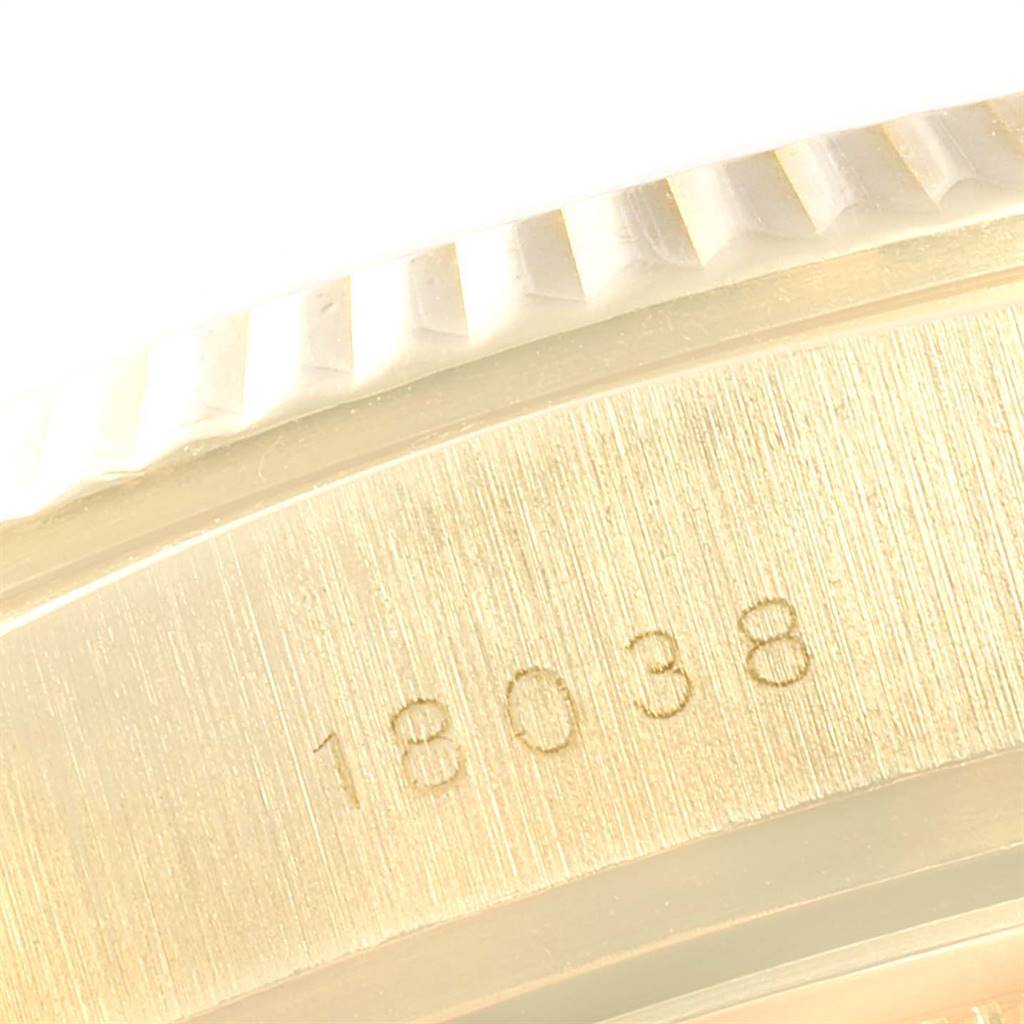 This close-up image of a Rolex President 18038 Men
s Yellow Gold Champagne Dial 18038 Men
s Yellow Gold Champagne Dial model watch shows the bezel and part of the case with the serial number "18038."