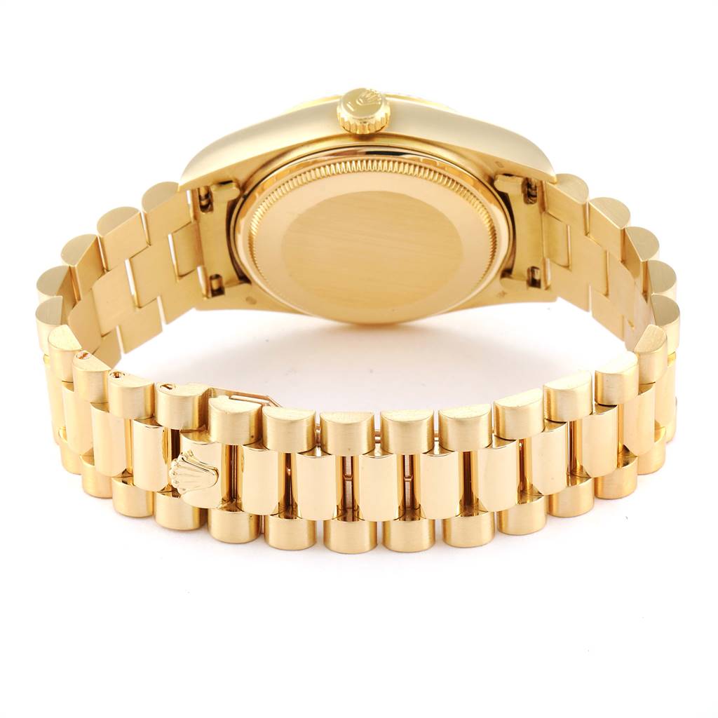 The image shows the back and clasp of the gold bracelet of a Rolex President 18038 Men
s Yellow Gold Champagne Dial 18038 Men
s Yellow Gold Champagne Dial model watch, with its case back and crown visible.